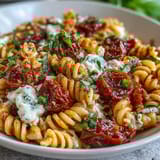 Golden Caprese Pasta with Burrata, tossed in garlic olive oil and finished with fragrant basil leaves for a fresh taste.