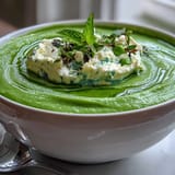 Light, refreshing pea soup topped with airy whipped ricotta and bright mint.