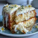 Zesty lemon cake adorned with floral elegance, perfect for celebration.
