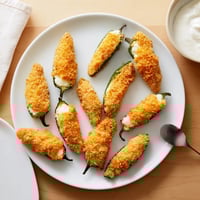 Golden brown Jalapeño Poppers stuffed with creamy cheese filling and served with cool ranch dip.