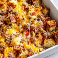 Freshly baked Breakfast Sausage Casserole with golden cheese and savory sausage chunks, resting on a rustic table.