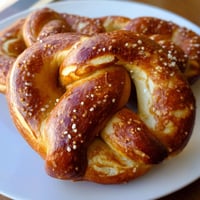 Freshly baked golden Soft Pretzels with coarse salt, twisted and brushed with egg wash, served warm alongside tangy yellow mustard on a rustic board.